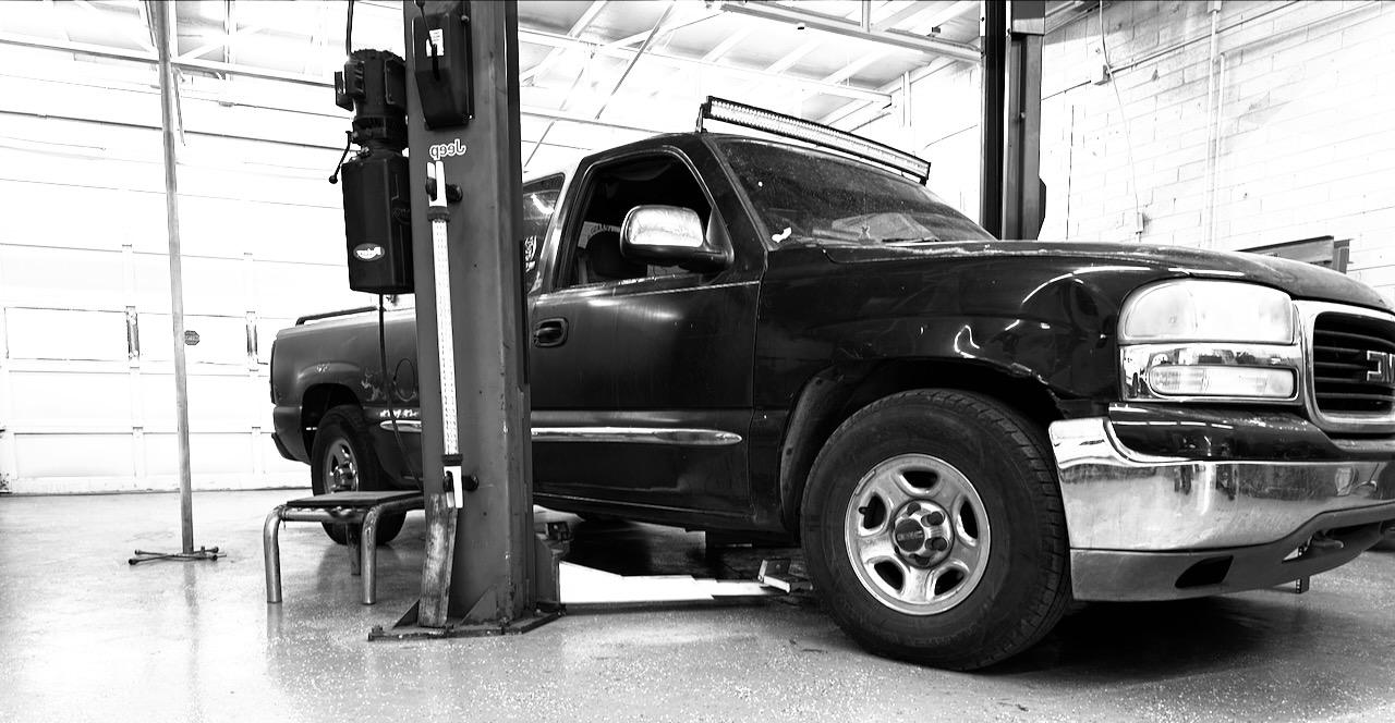A pickup on the lift inside Ironwood Automotive in Tucson